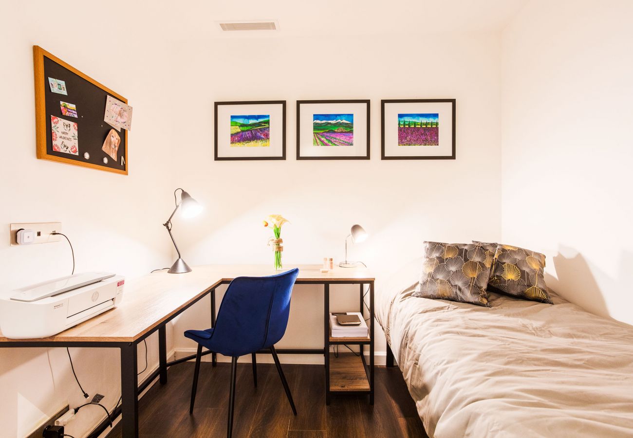 bedroom with single bed and desk