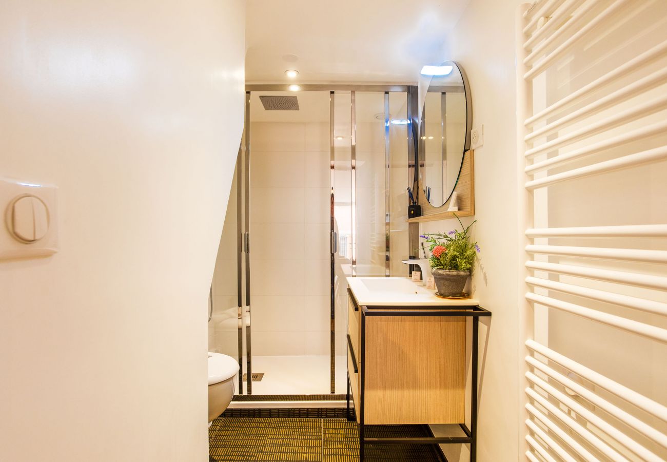 bathroom with shower and towel dryer