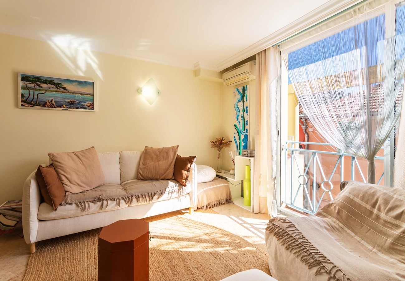 Cozy living room with a double sofa bed, natural light, and tasteful decor. Perfect for relaxing or hosting guests