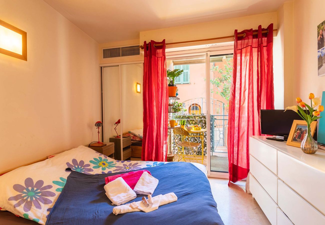 Cozy bedroom with a balcony and comfy bed. A perfect space for peaceful nights in a charming atmosphere.