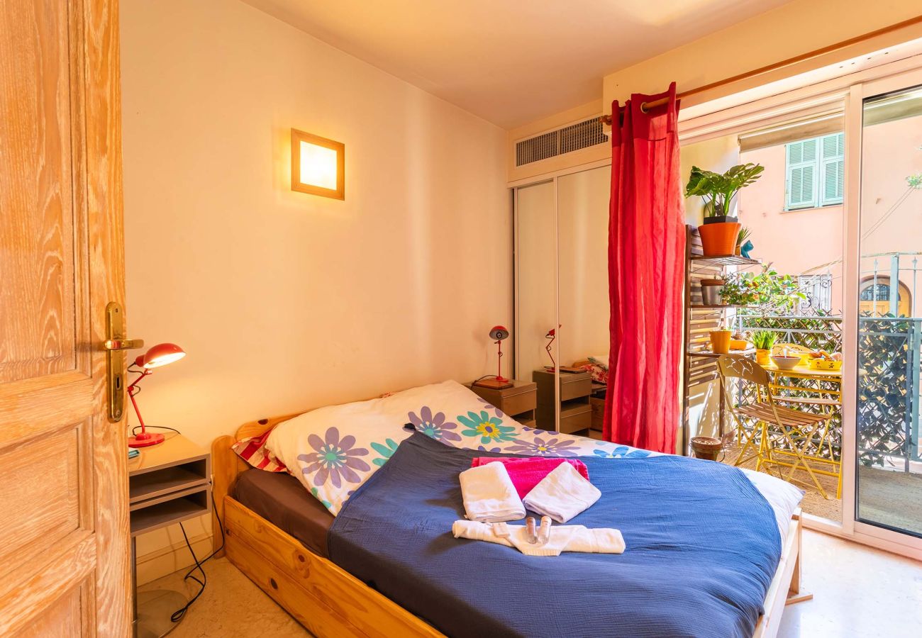 Cozy bedroom with balcony, natural light, and elegant decor. Perfect for relaxing indoors or out.
