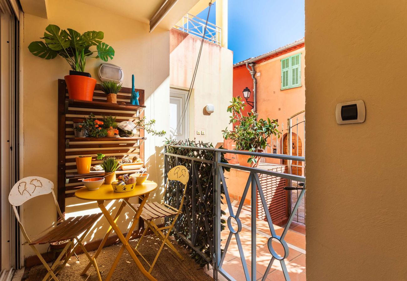 Sunny balcony with lush plants and vibrant furniture. A peaceful spot to enjoy the outdoors in complete serenity.