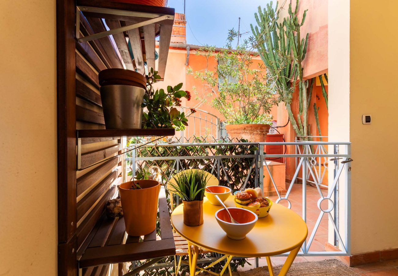 Cozy outdoor corner, perfect for relaxing or dining al fresco surrounded by greenery.