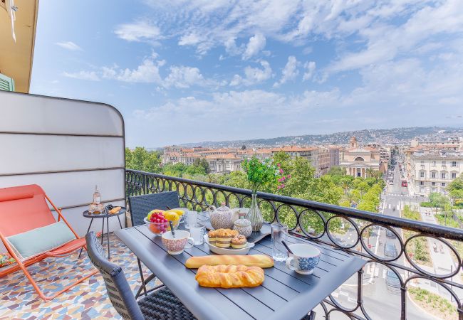 Balcony with furniture and open view over central Nice